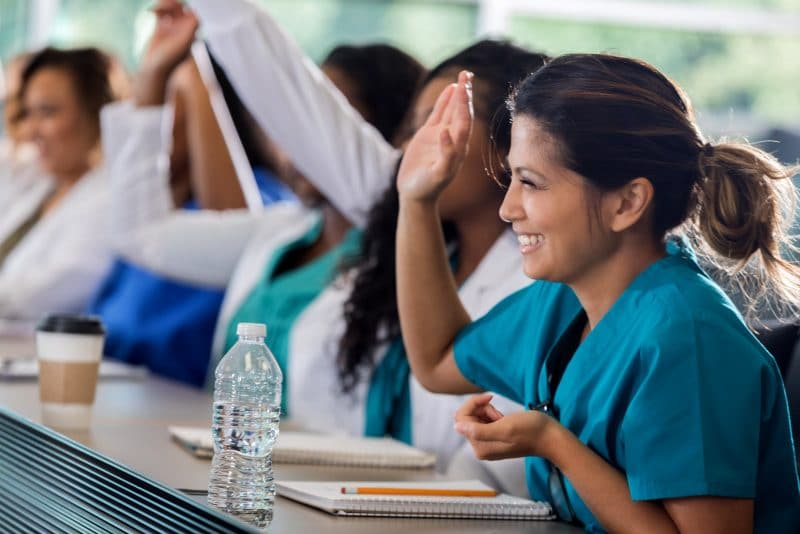 edu nurse raising her hand